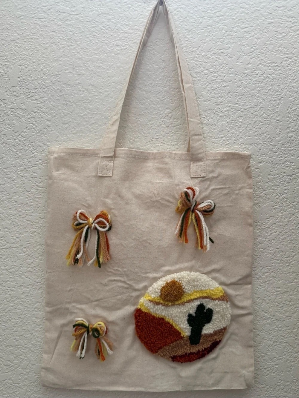 Handcrafted Cream Canvas Tote Bag with Multi-Color Tassel Appliqué
